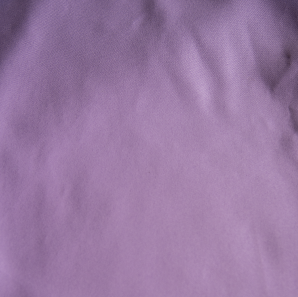 Close up of a lavender colored polyester tablecloth.