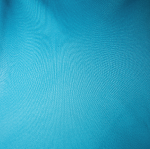 Close up of a turquoise colored polyester tablecloth.