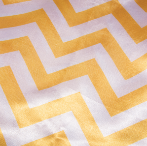 Close up of a yellow chevron patterned tablecloth.
